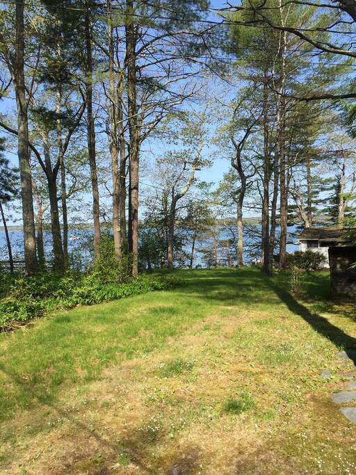 Grassy lawn leading to water.