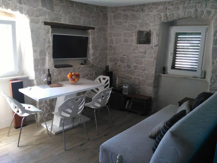 Living room with dinning table and smart tv.