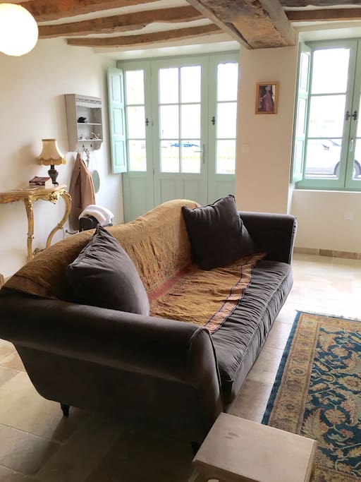 Noveau salon with comfortable sofa in front of the wood burner on winter evenings