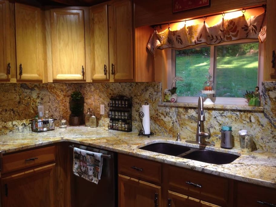 Dishwasher and cabinets stocked with dishes, pots, pans and silverware