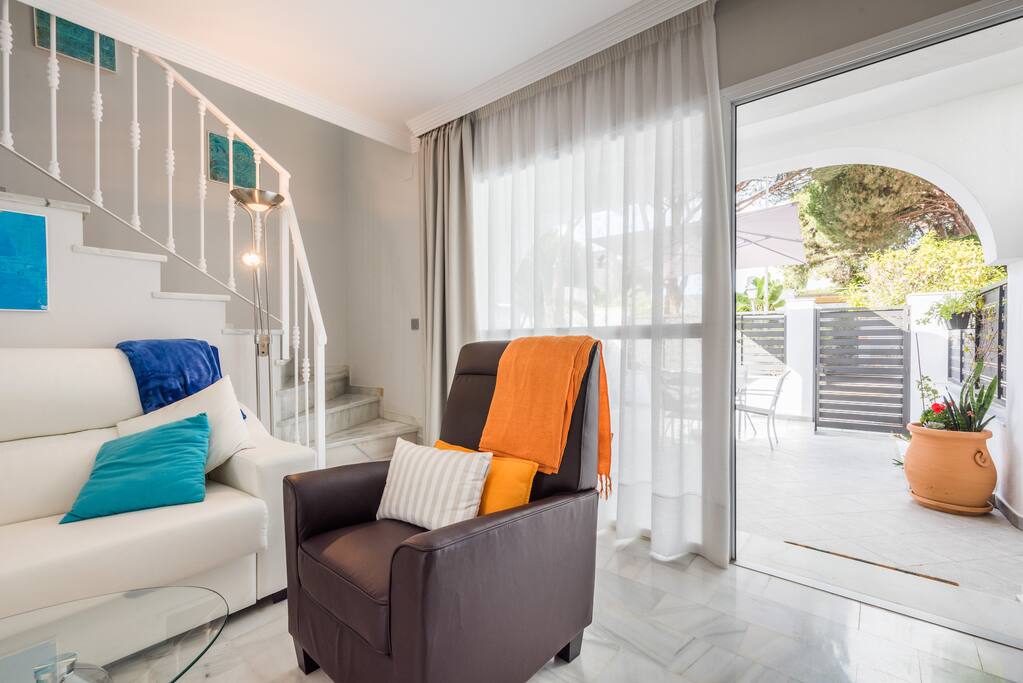 Living area leading to front terrace, dining and secure gate/walls