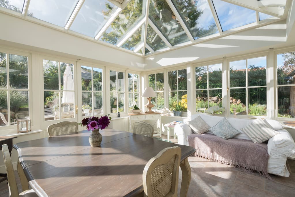 A large and spacious orangery with great views over the garden a glass covered well and underfloor heating