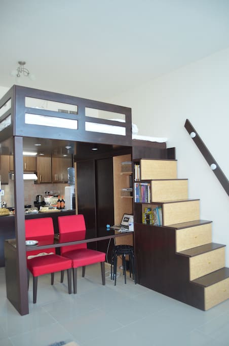 Loft unit queen size bed and working area below.