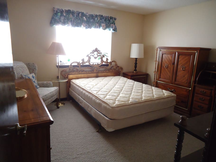 Bedroom with queen size bed and modern contemporary bedroom furniture.