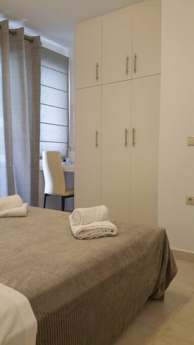 Double bedroom with fitted wardrobes, vanity area and access to rear balcony