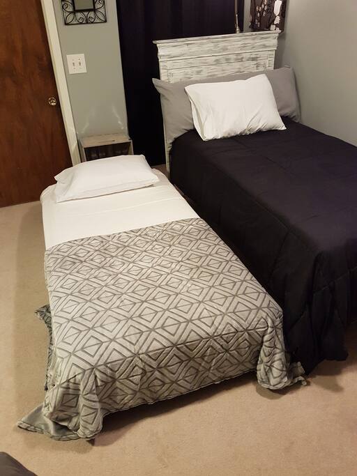 Trundle bed w/ 1.5" memory foam topper rolls out of sight when not needed. It can be raised.