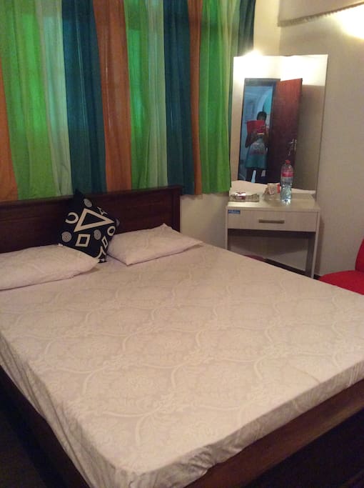 Clean white bed sheets and pillow cases and cushion Double bed with 06 inch comfy mattress for a comfortable sleep .