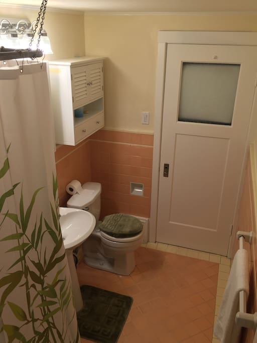 This private bathroom has all the basics... plus a few extras in the cabinets to help make your stay complete.