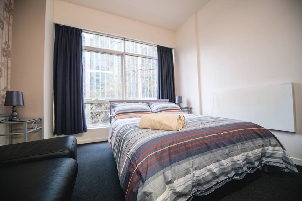 A queen sized bed & plush pillows.