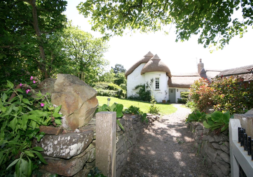 Private gardens with play area and private tennis court next to our dog friendly beach ...