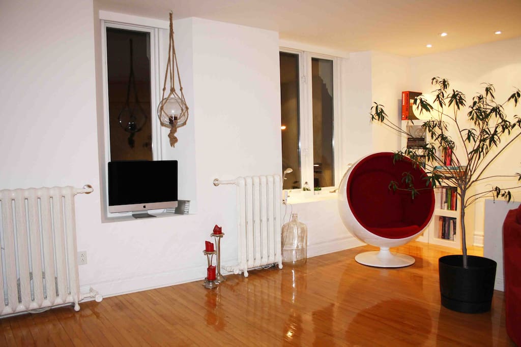 Living room area: reading corner, books and chair