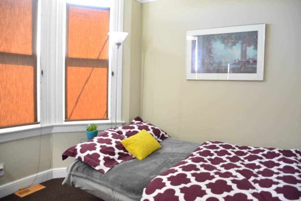 Your bedroom right next to front entrance. Beautiful morning sunlight through bay windows. Full-sized futon: super comfortable with plush memory foam topper.
