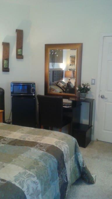 Has a microwave refrigerator computer desk.