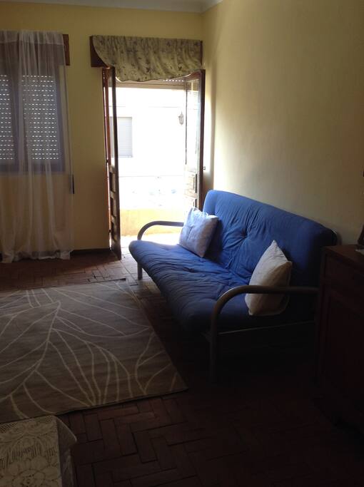 Spacious and bright living room leads you to a long veranda , futon opens up to sleep two more people