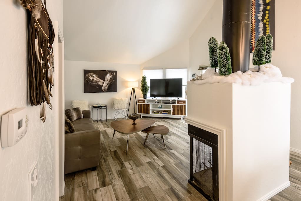 Living room with large flatscreen, fireplace and multiple seating options