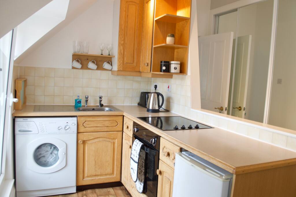 There is a compact kitchen area which includes a washer if you need to clean your clothes.