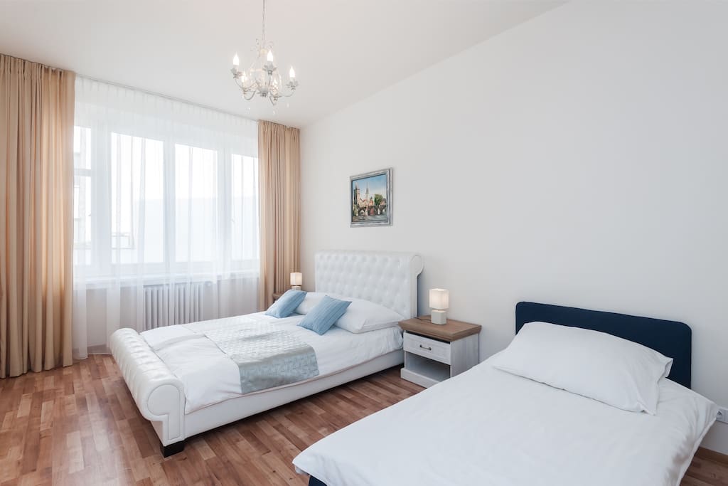 First Bedroom with Queen Bed and Single Sofa Bed
