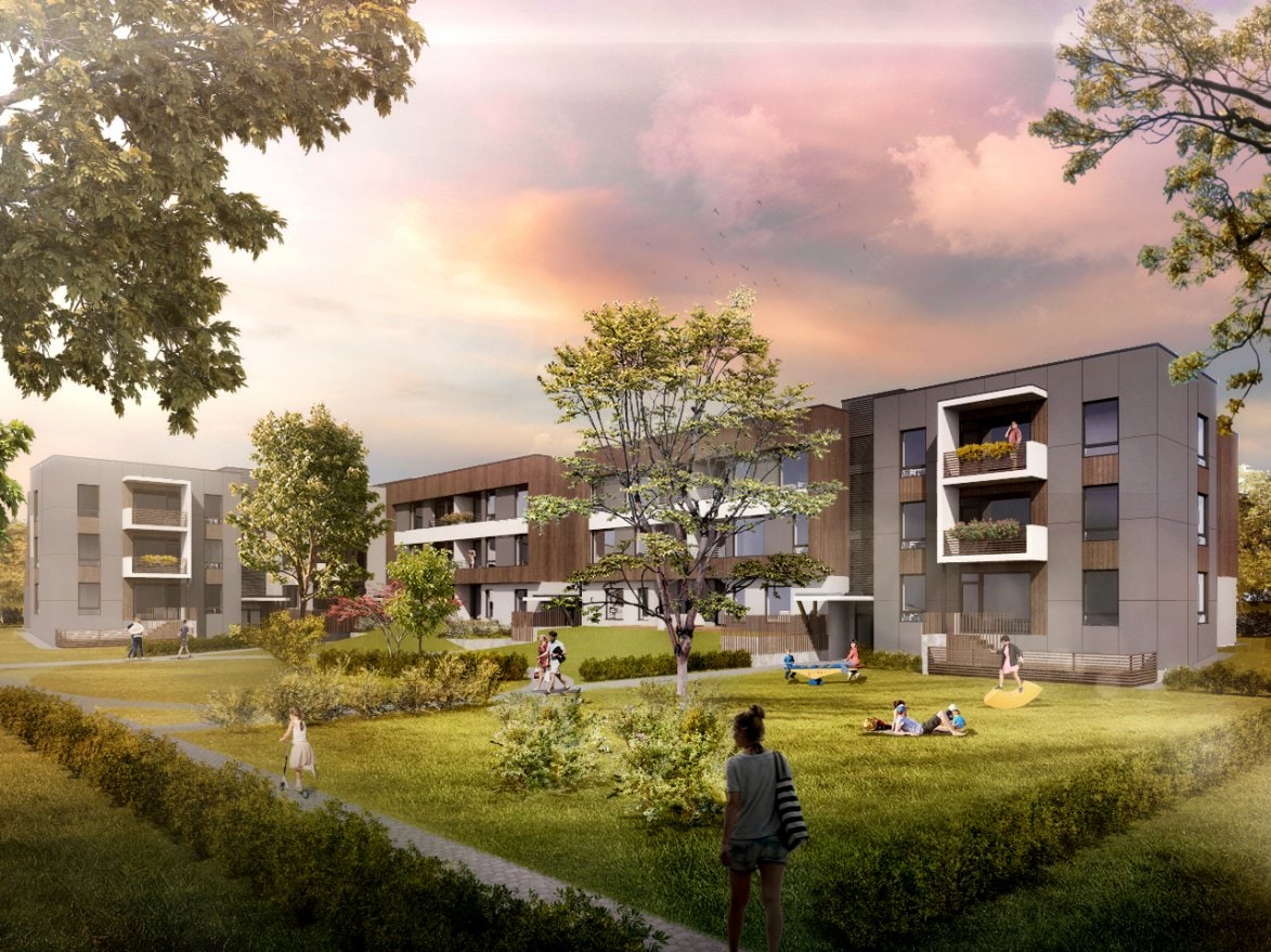 The image depicts a modern apartment complex surrounded by greenery, featuring interspersed trees and shrubs. Residents can be seen relaxing on the lawn and enjoying outdoor activities. The buildings showcase large windows and balconies, emphasizing a connection to the natural landscape.
