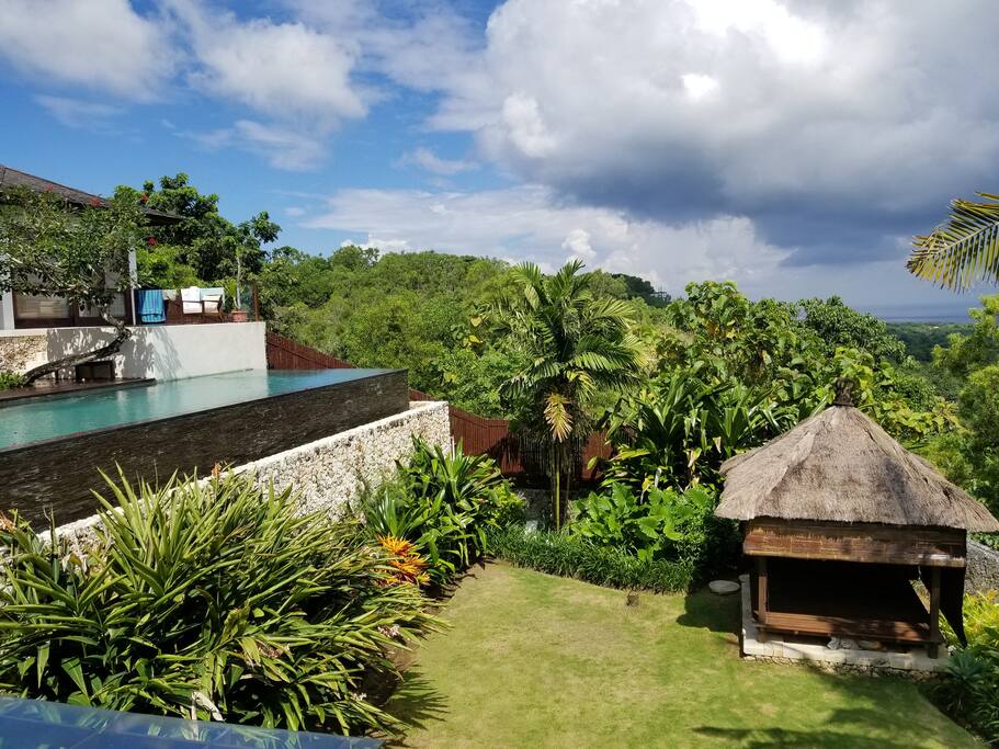 garden area with infinity pool and gazebo