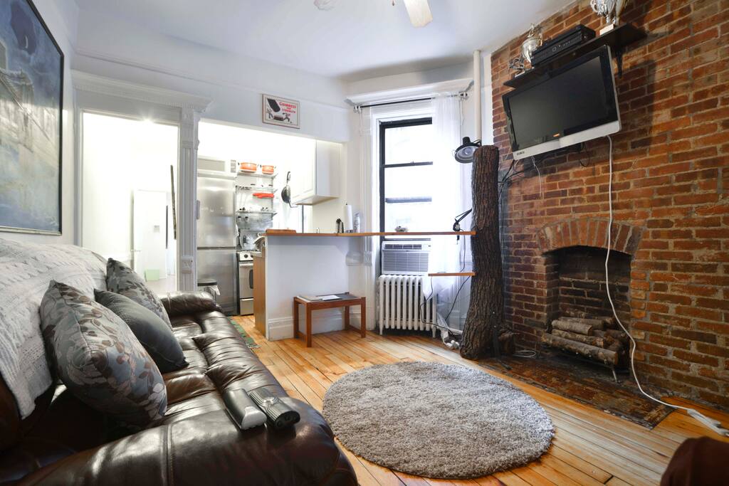 Exposed brick, rustic hardwood floors.