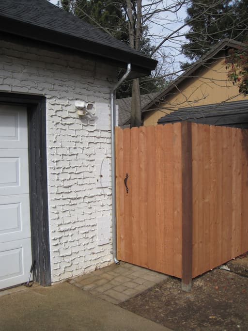 Entrance through the gate on the right of the main house.