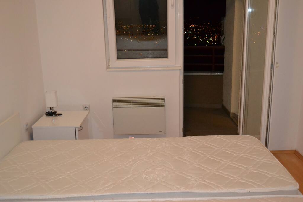 Bedroom + door to balcony