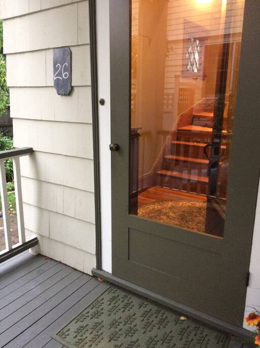 Front door showing stairs leading up to the unit.