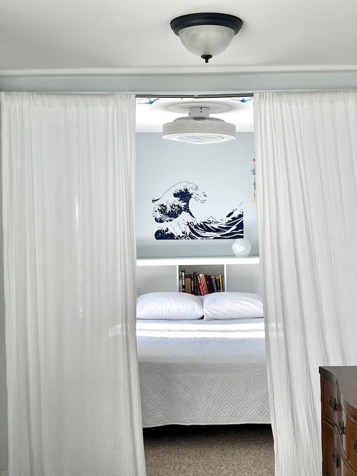 Sleep sanctuary alcove is located on the front sun porch.