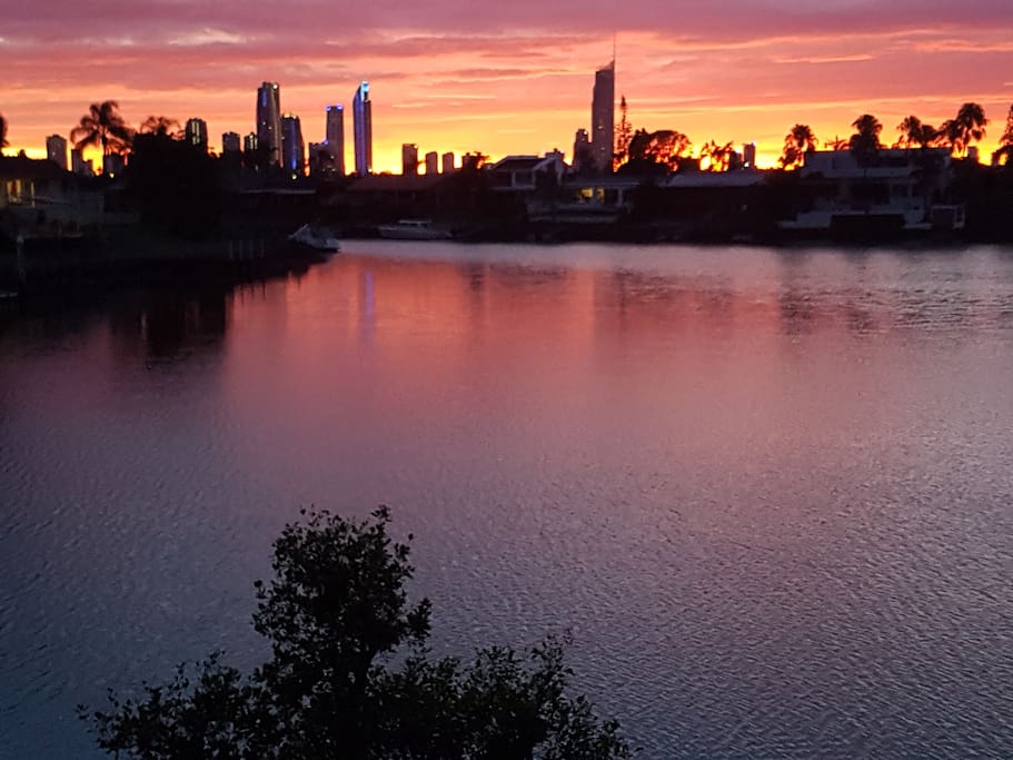 Looking at silhouette of Surfers Paradise at night from back garden. Sunbeds provided down by the water's edge.