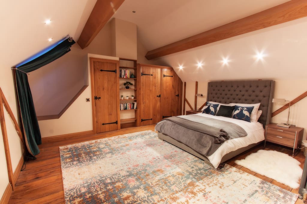 Master bedroom with door to secret staircase to lounge.
