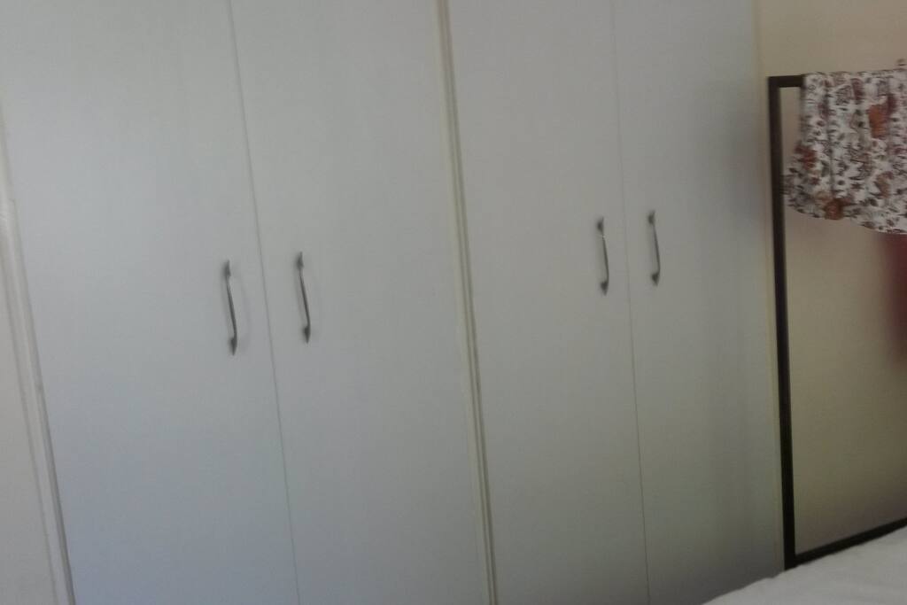 Cupboard space in bedroom and clothing rail