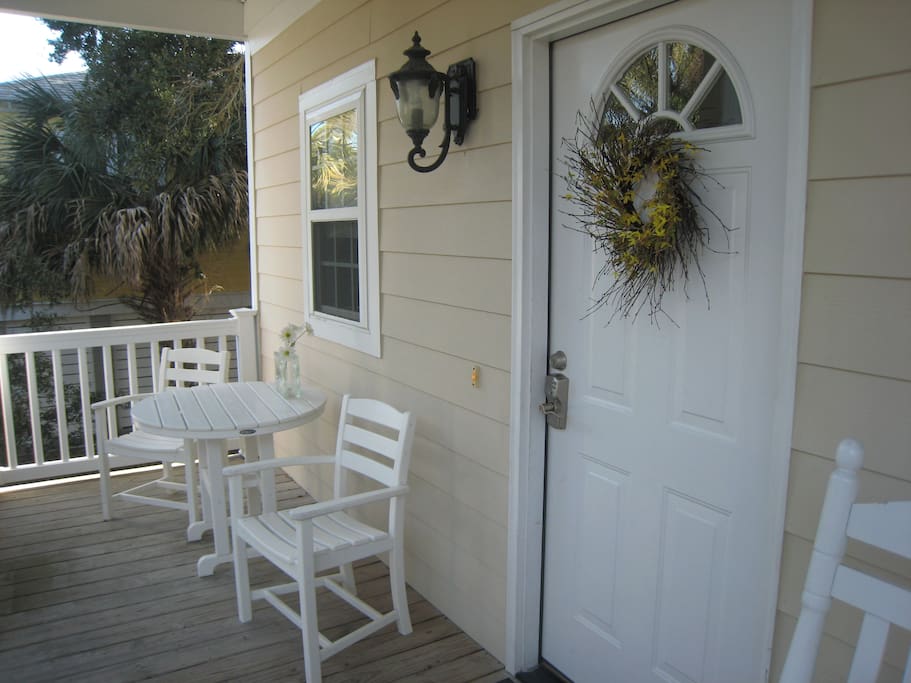 Welcoming front porch with a table and rockers.