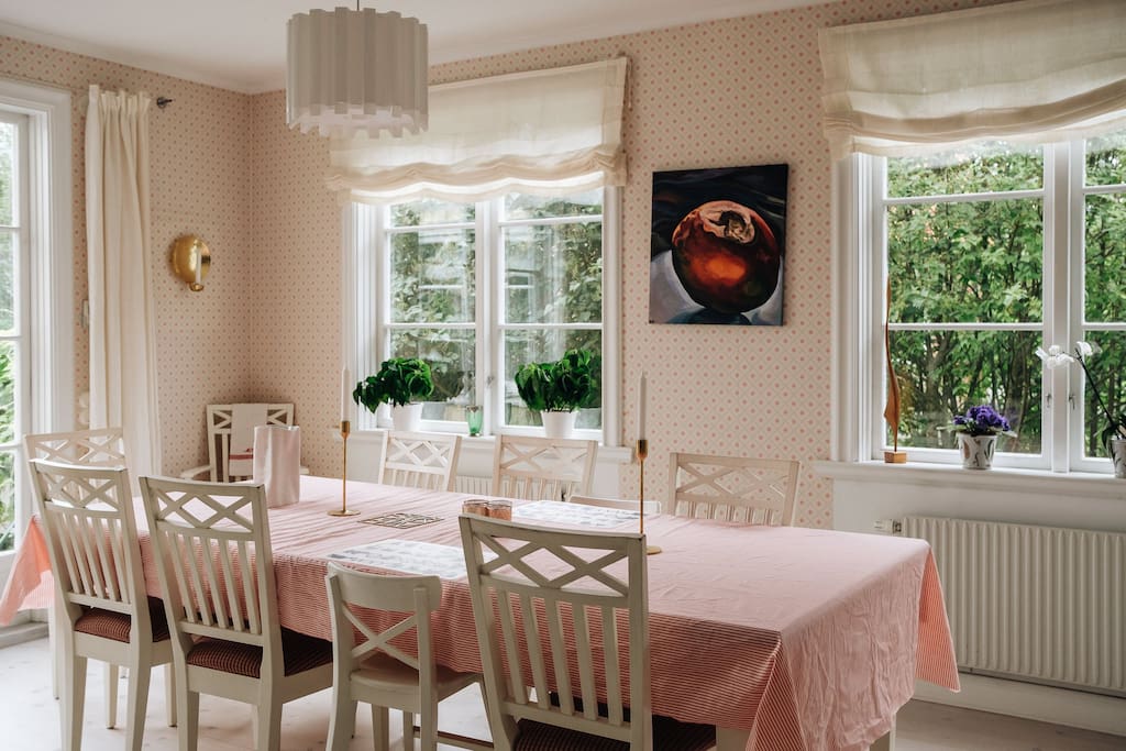 very spacious and bright dining room with French doors out onto the terrace