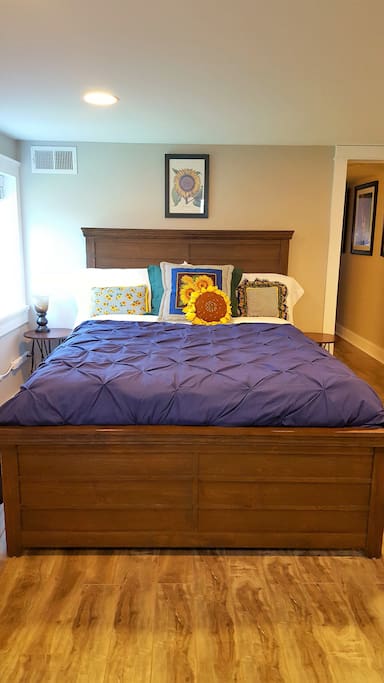 The bed is queen sized with a pillow top mattress. There are two king sized pillows on the bed. Both the pillows and comforter are polyester. We have different sets of sheets and duvet covers, so the linens may not match the pictures.