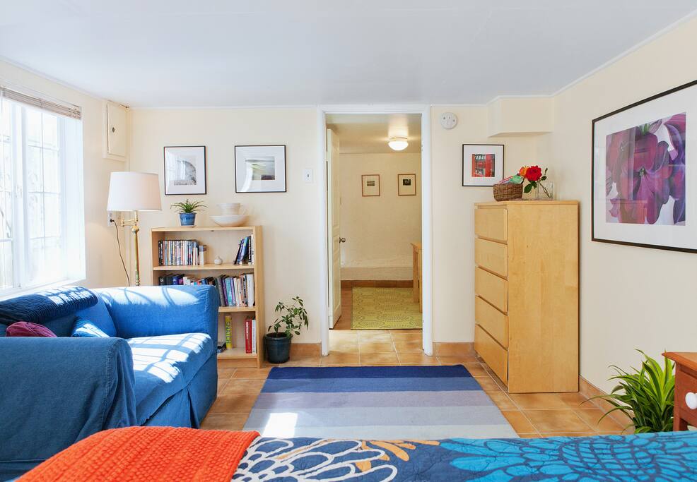 Spacious living area with dresser and closet, stocked with DVDs and player, travel books, and board games.