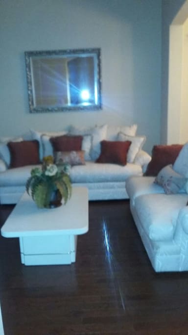 1 of 2 large living spaces. Wood floors, comfortable furniture. Cable/satellite televisions in living spaces and bedroom
