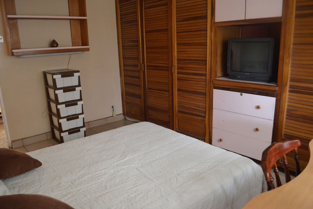 Well lit room with double bed and plenty of closet space. TV with cable inside the room.