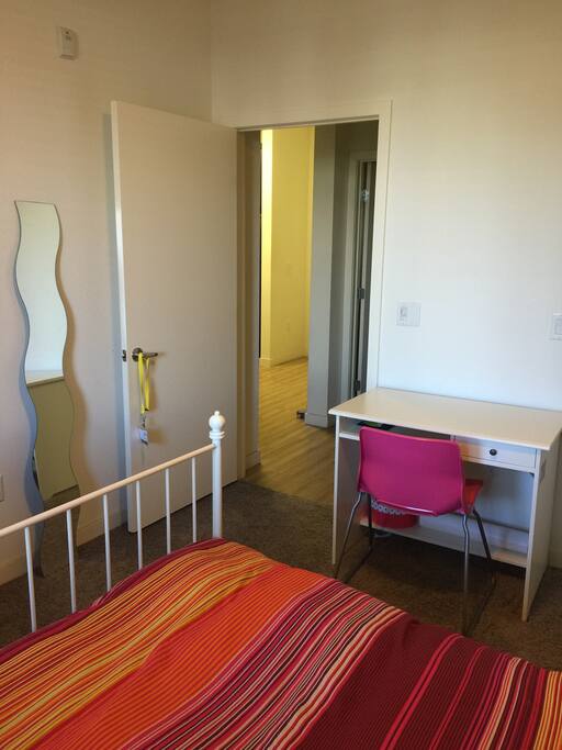 This private room includes a desk, a chair and a mirror.