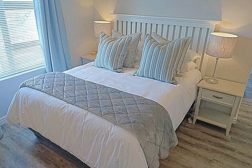 One of the spacious downstairs bedrooms with sliding doors to the garden, loads of storage space and with one queen size bed