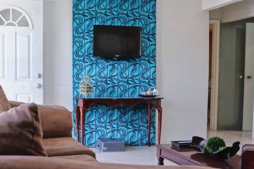 Living room with cable television, couch, loveseat, coffee table, and games