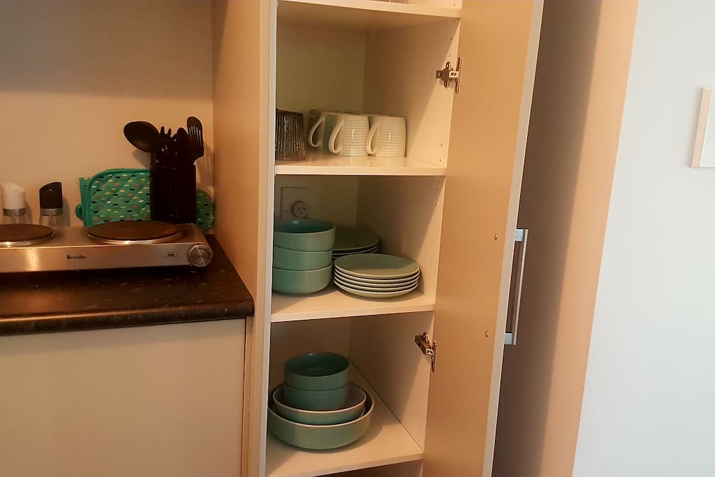 showing one of the open cupboards on kitchen.