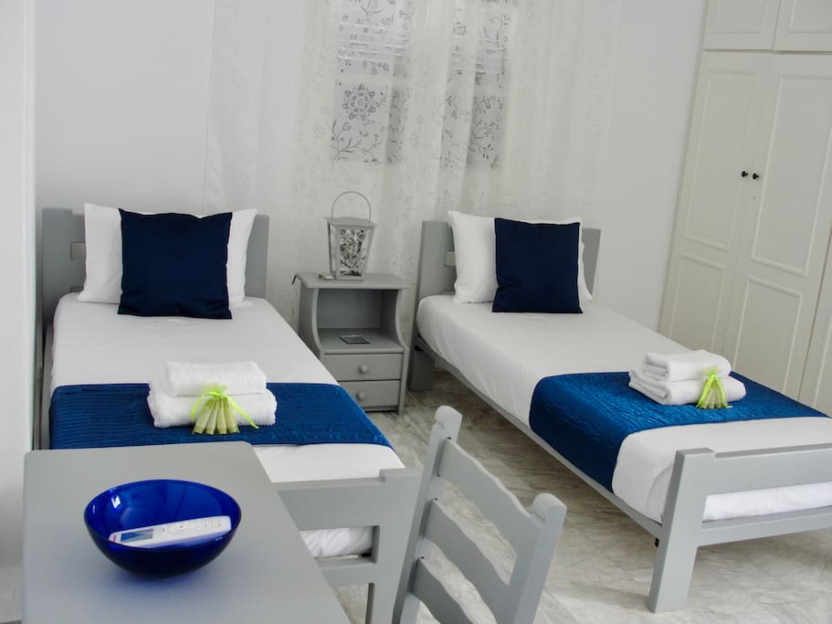 Main bedroom - 3 beds, desk, wardrobe, air con, balcony window