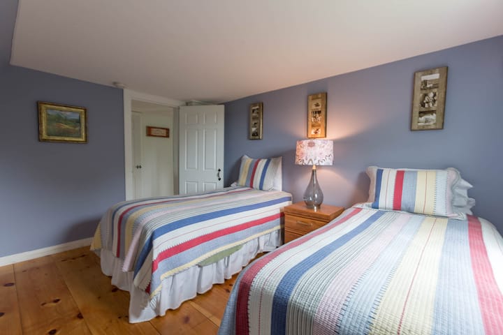 2nd bedroom in the original house. 2 twin beds, drawer storage and luggage racks.
