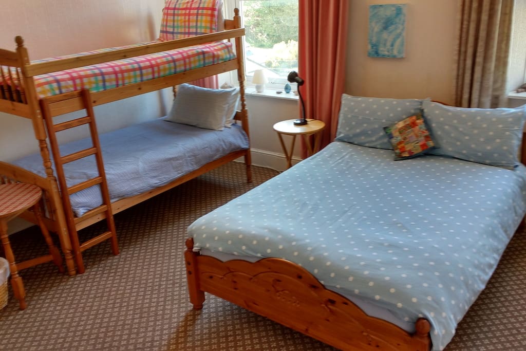 Our peaceful family room with a double bed and 2 kids bunks.