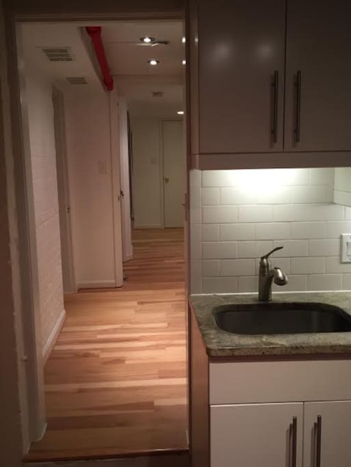 Perspective shot from kitchen into hallway and bedroom