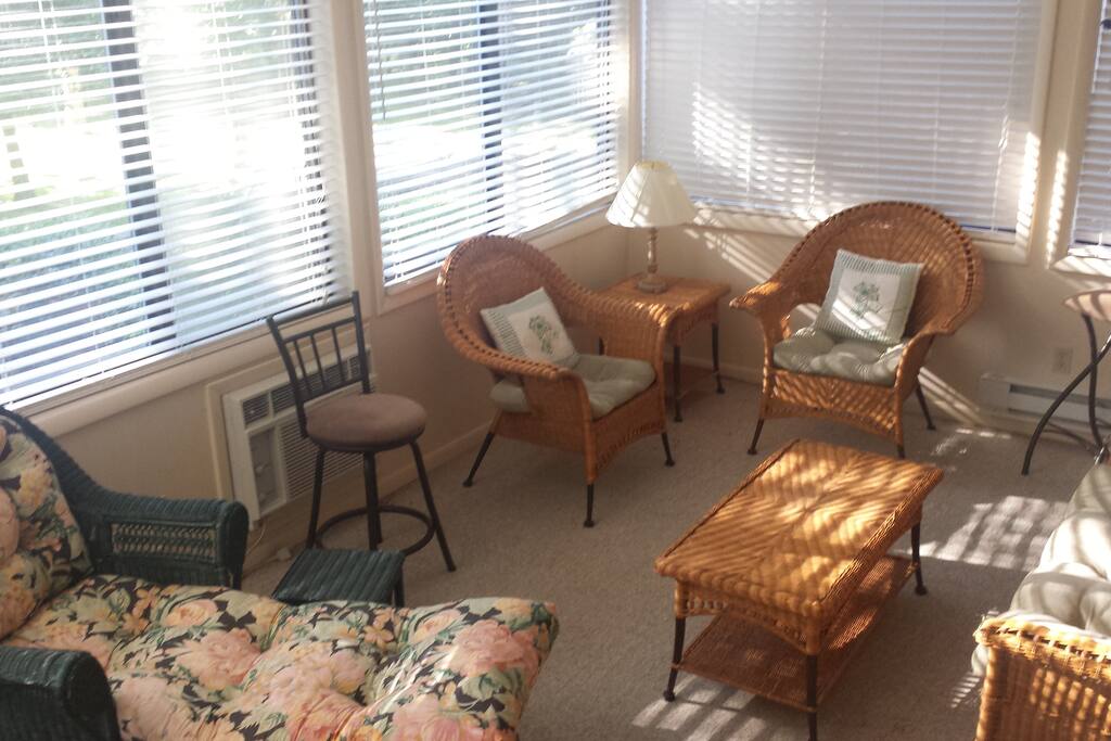 Well lit, cozy sunroom.