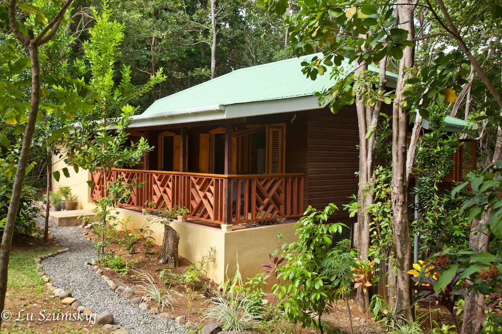 Verandas face the garden in front, the forest and ocean in back