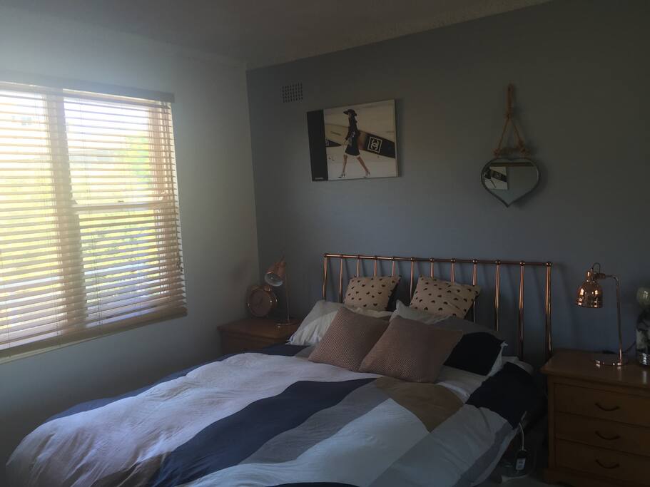 Sunny room with balcony and King size bed.