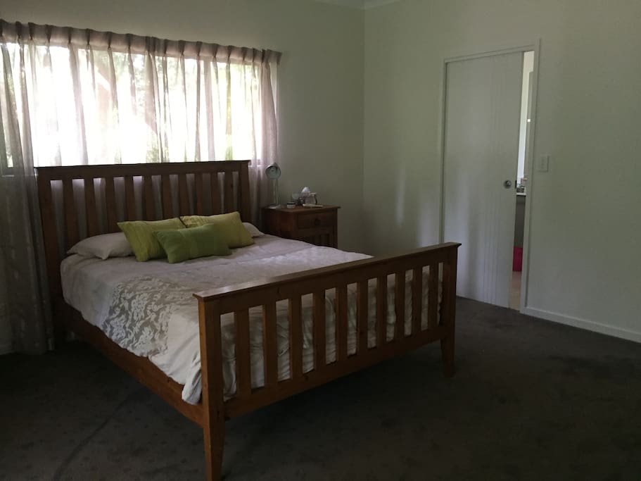 The main bedroom has a king sized bed, access to the deck, and an ensuite