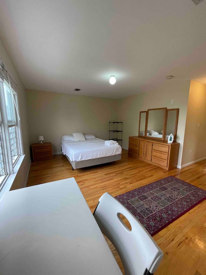 Spacious Master bedroom with queen memory foam mattress, table/chair, dresser, iron etc. Jacuzzi bathroom shown in other photos is attached. Towels, shampoo, conditioner, body wash provided.